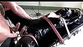 Blindfolded Girl In Latex Overal Tied To Medical Bed Getting Her Pussy Ass... Porn Video